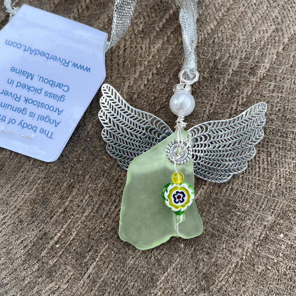 Handmade uranium glass angel ornament with floral heart charm and silver wings on wood