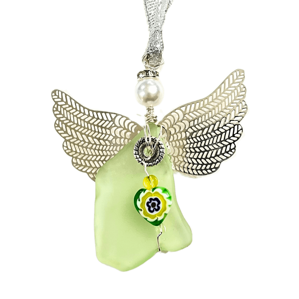 Close-up of "Midnight Radiance" angel ornament with glowing green beach glass and floral charm
