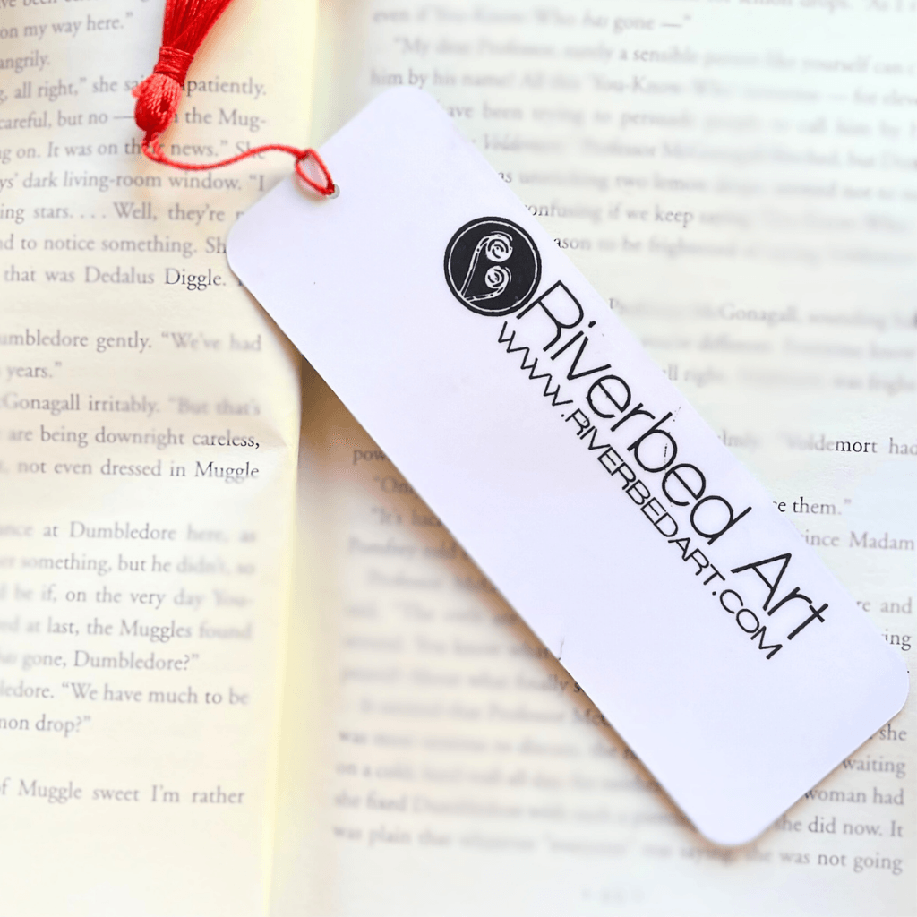 Handmade Winter Chickadee bookmark showing Riverbed Art logo on the back.