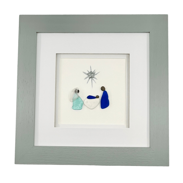 Aroostook Nativity framed artwork made with Aroostook River beach glass, river pebbles, and pottery in a grey wood frame.