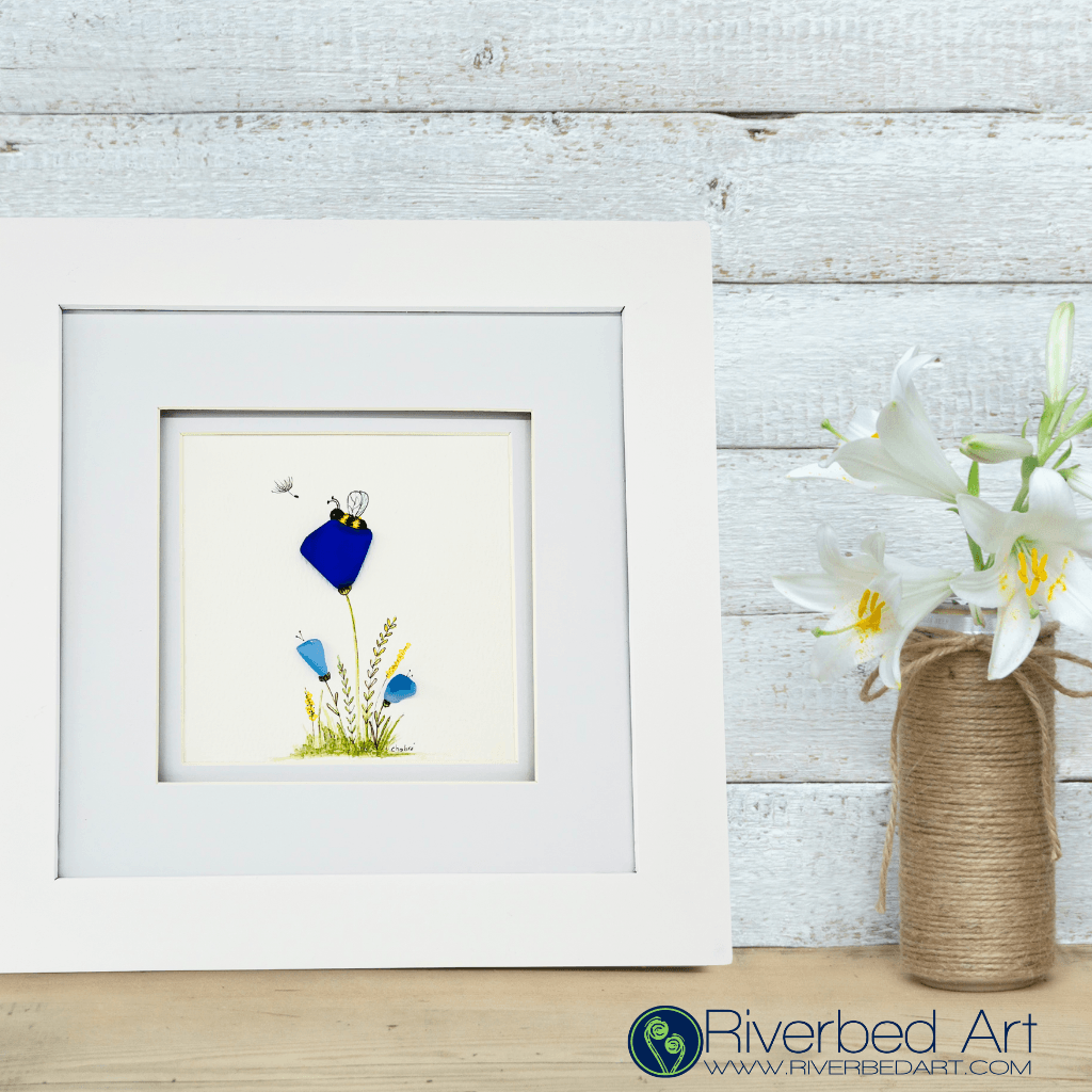 Detail view of Rest artwork in wood frame with hand-illustrated landscape and river glass flowers