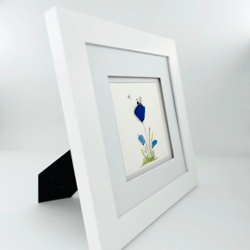 Angled view of framed Rest river glass flower artwork displayed on a flat surface