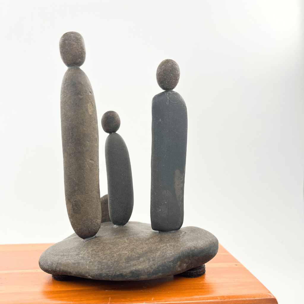 Back view of Family & Love stone sculpture showing three river stone figures