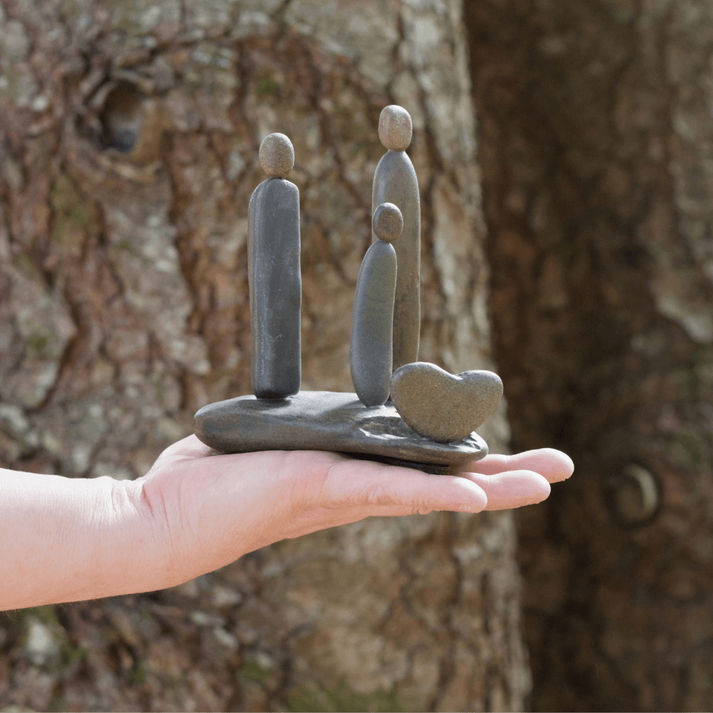 Family & Love Aroostook River stone sculpture held in hand for size reference