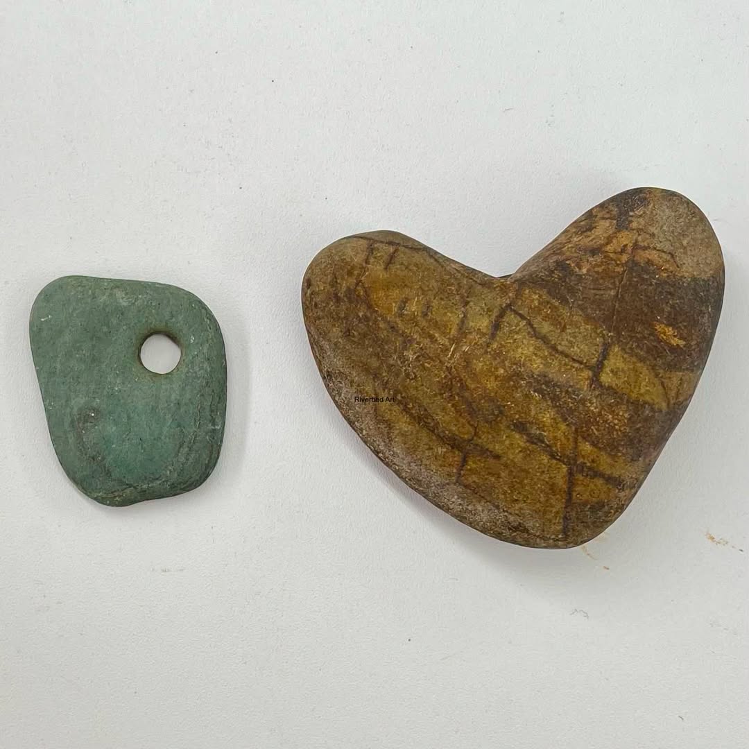 Naturally heart shaped river rock and smooth green stone with a hole found in the Aroostook River in Caribou, Maine.