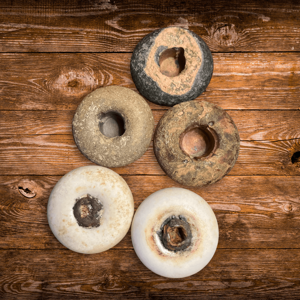 Backs of five old ceramic, stoneware, and porcelain doorknobs found in the Aroostook River