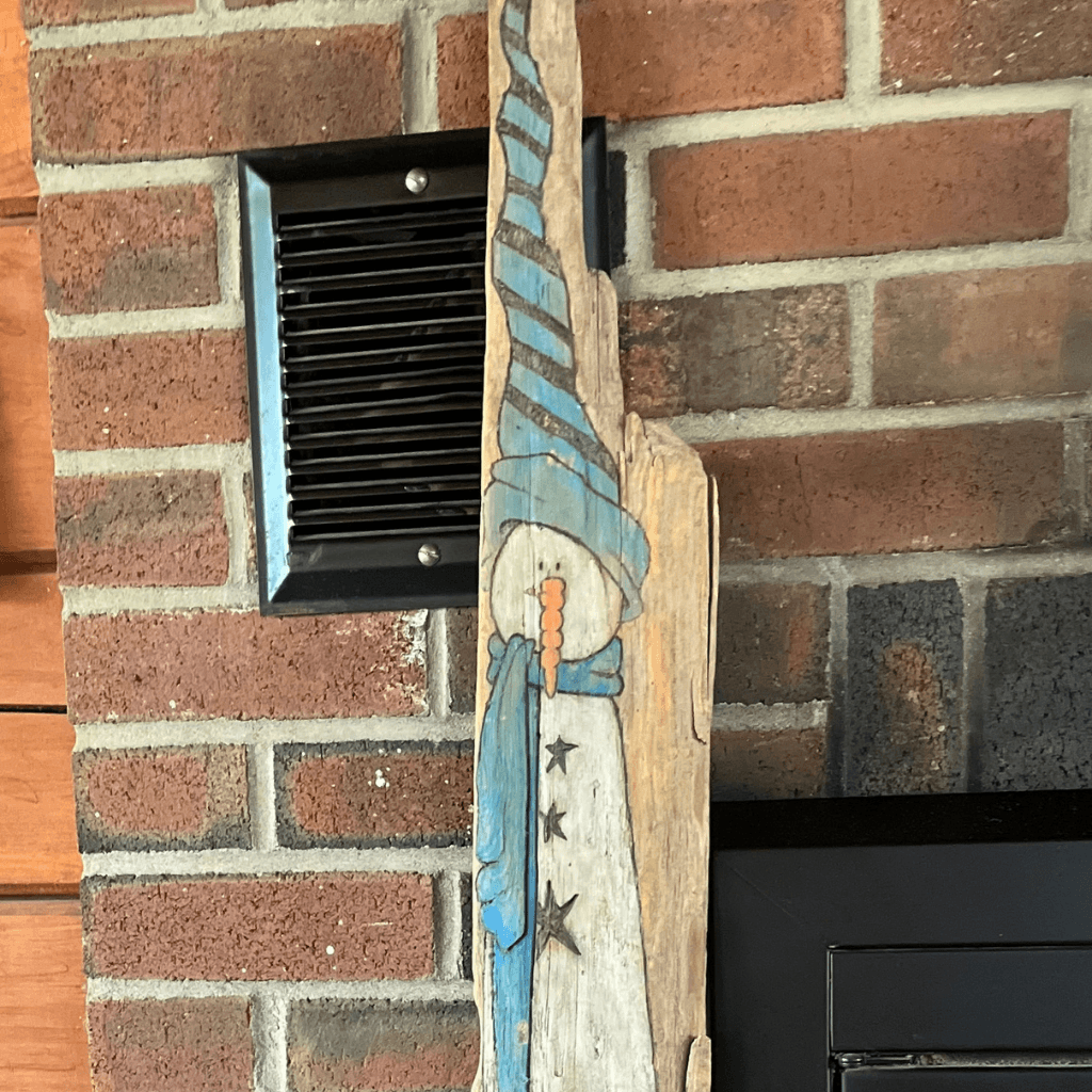 Early driftwood snowman with blue painted details, made by Kim Chabre